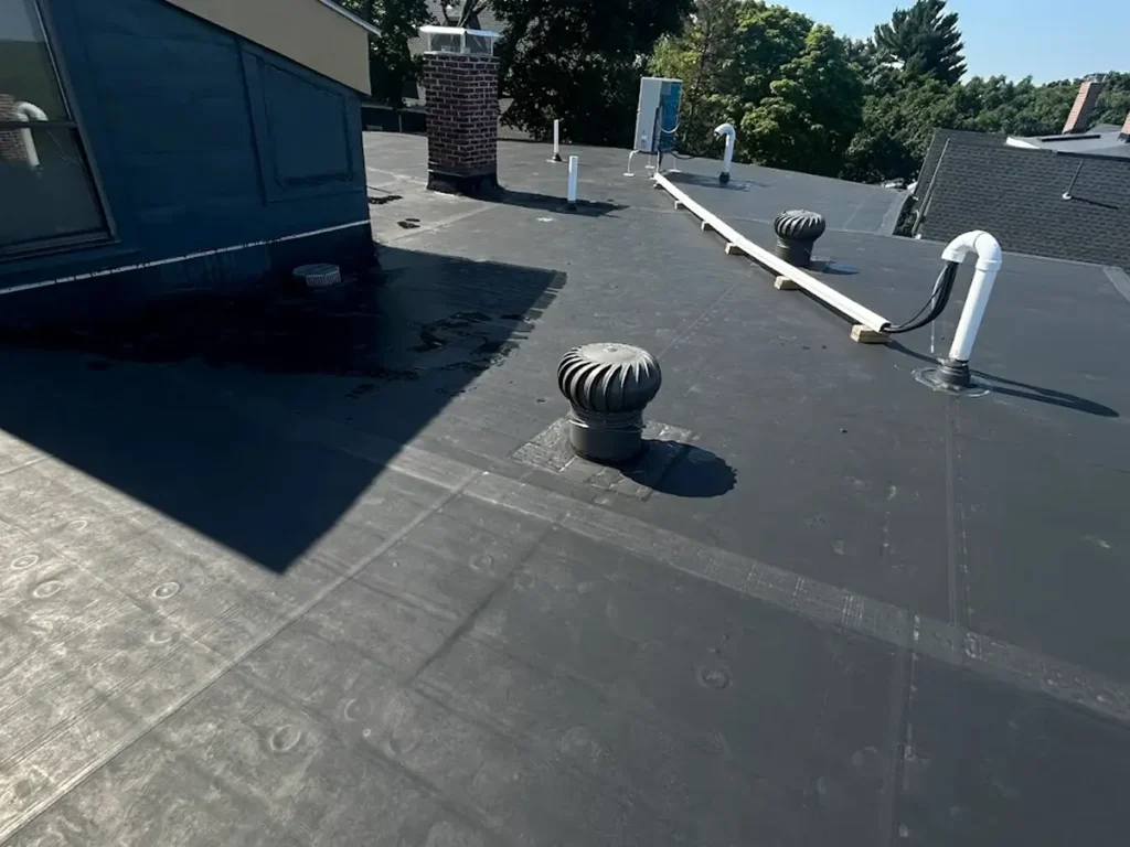 Post-repair view of a rubber roof with a smooth, waterproof surface.