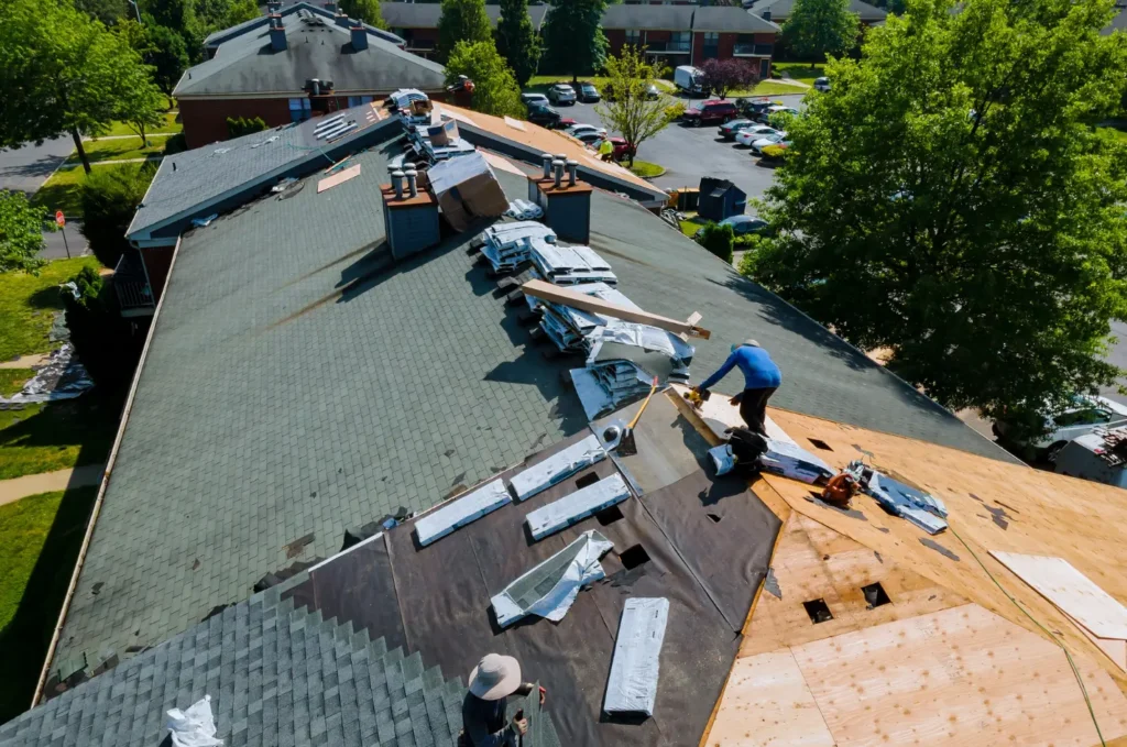 Workers handle same-day roof repair Boston on a large roof to replace shingles and reduce leak damage after fast inspection. 