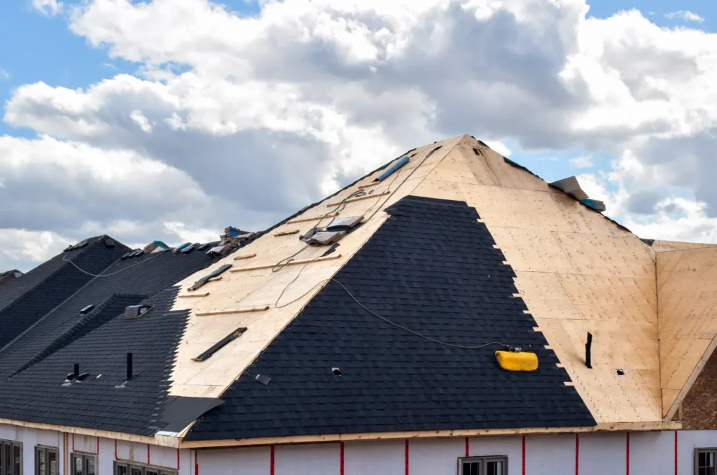 Exposed roof decking during emergency roof leak repair shows where water can enter before same-day roof repair in Boston. 