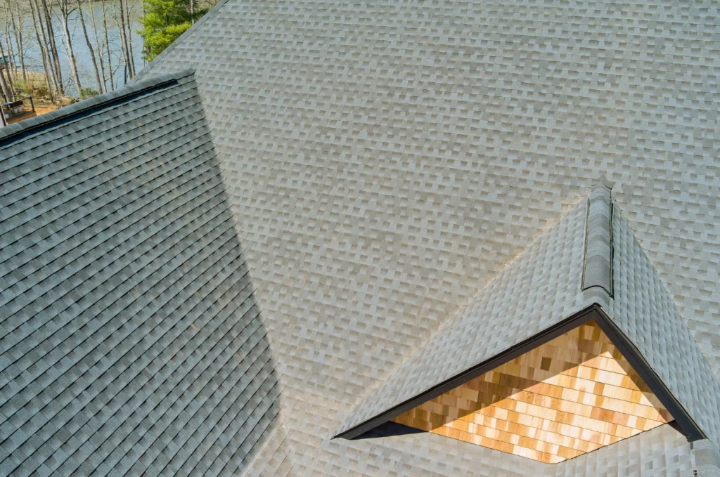Large residential roof with clean shingles and multiple slopes, showing the type of areas commonly reviewed during a roof inspection