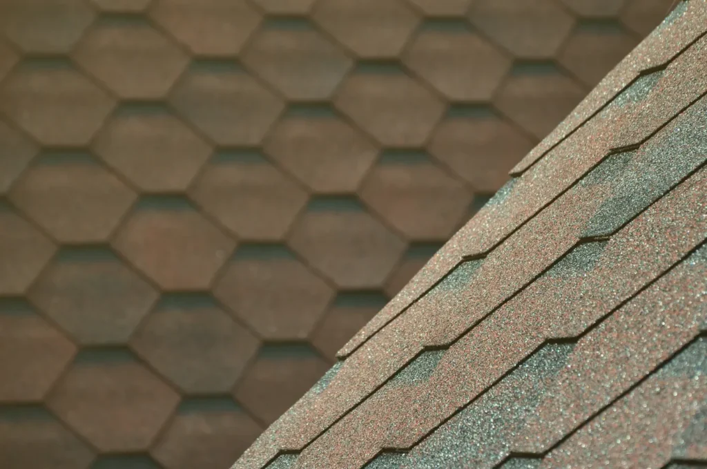 Close-up view of asphalt shingles in different styles, often used during an emergency roof repair after wind or storm damage