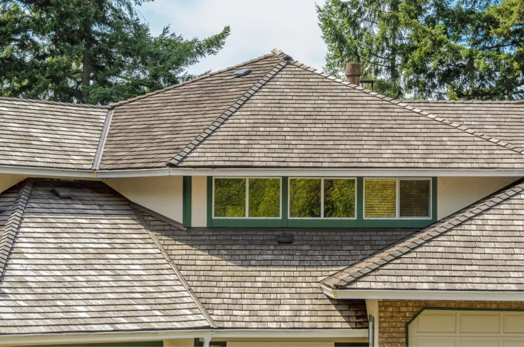 Large residential roof with several slopes and valleys, areas often checked during an emergency roof repair inspection