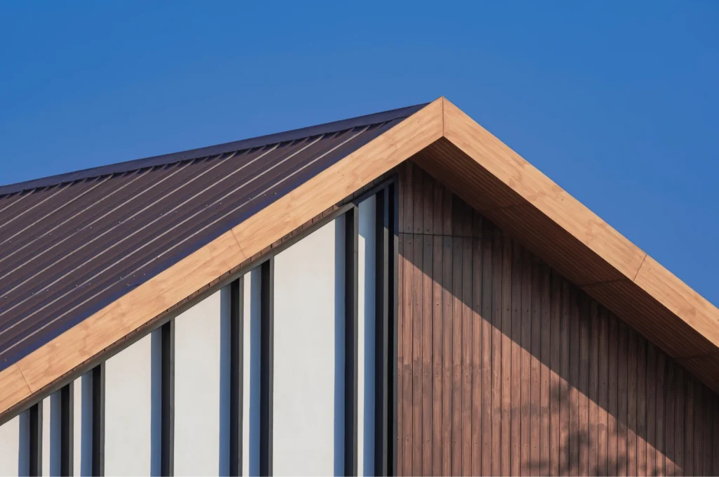 Modern home with a metal roof and wood siding, highlighting clean lines and durable materials after a roof repair project