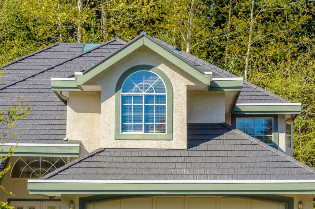 Large home with a durable tile roof and multiple slopes, showing the finished results of a professional roof repair