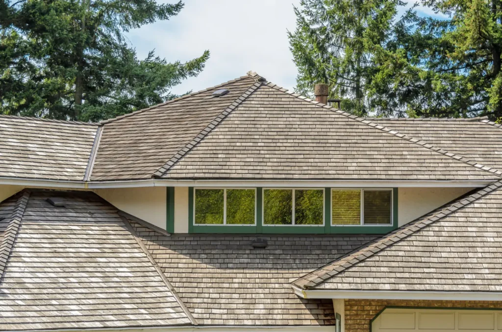 Large residential home with multiple roof sections and durable shingles after a small roof issue repair restored protection.
