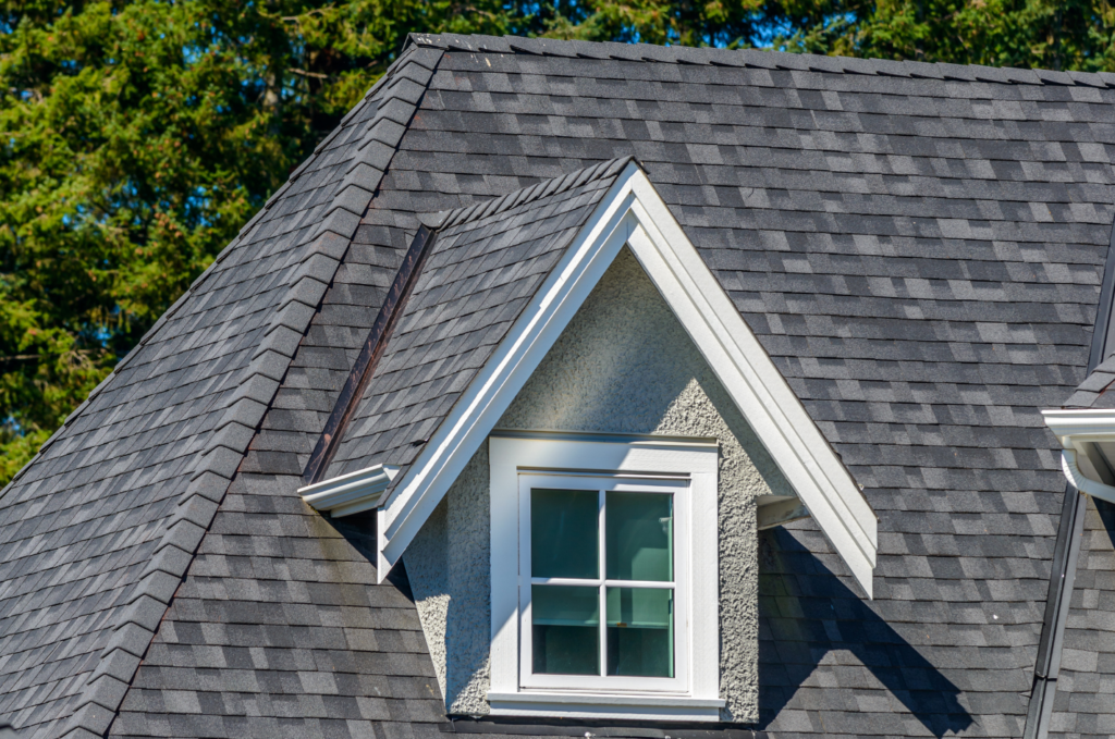 Asphalt shingle roof and dormer checked after storms for early roof damage signs before urgent roof repairs are needed soon. 