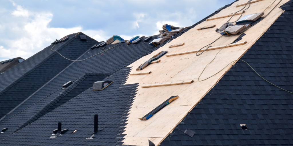 Exposed roof decking during emergency roof repair service shows damage control before permanent roof work begins in Boston. 