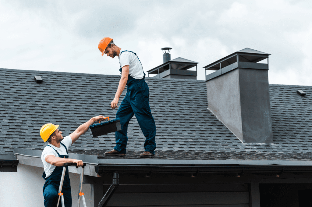 Roofing contractors prepare tools and access points during a Boston roof installation checklist before work begins on a home.