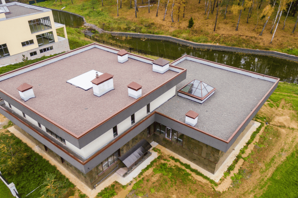 Aerial view of a flat roof property showing drainage areas and roof sections reviewed during flat roof maintenance in Boston.