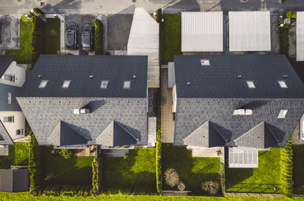 Aerial view of residential roofs showing roof sections that may be documented during a pre-purchase roof inspection report. 