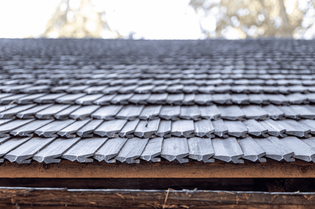 Close-up of worn wooden roof shingles showing surface conditions that may be reviewed during a professional home roof inspection.
