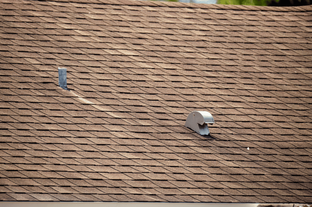 Brown shingle roof with vents and penetrations checked for storm damage during a professional home roof inspection in Boston.